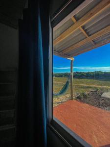 a window with a hammock looking out at a field at Rinkeby in La Esmeralda 