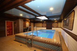 a large room with a swimming pool in a house at Boutique Hotel Absolute in Saratov