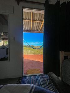a bedroom with a view of the desert through a door at Rinkeby in La Esmeralda 