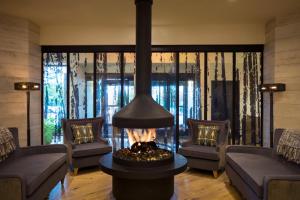 a living room with a fireplace in the middle at Portland Sheraton at Sable Oaks in South Portland