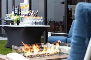 a fire pit in front of a table with wine glasses at Portland Sheraton at Sable Oaks in South Portland