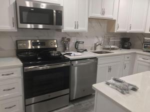 a kitchen with a black stove and a microwave at SUITE B - Private Cozy, Spacious Suite with Private Bathroom in Bowie