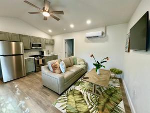 a living room with a couch and a kitchen at The Wildflower in Siesta Key