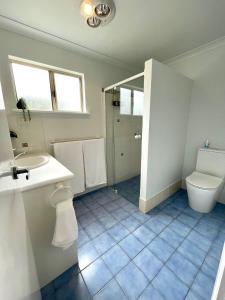 a bathroom with a toilet and a sink at Kangaroo Island Seabright Garden Cottage in Kingscote