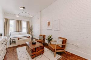 um quarto branco com uma cama e uma mesa em East Main Lofts - Farmhouse 204 em Madison