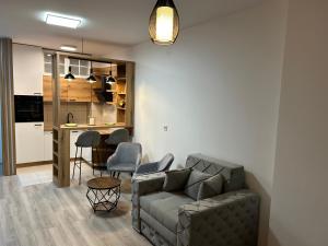 a living room with a couch and a kitchen at De Lux Nedeljkovic President in Jagodina