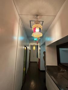 a hallway with a chandelier and a hallway with a person in it at Hotel shirahama in Shirahama