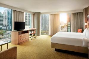 a hotel room with a bed and a desk with a television at Residence Inn by Marriott San Diego Downtown/Bayfront in San Diego