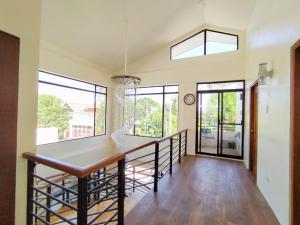 a dining room with a table and windows at Casa Maris in Bacoor