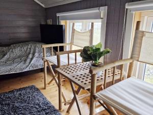 Habitación con 2 sillas, mesa y cama en Holiday home Averøy VII, en Averoy
