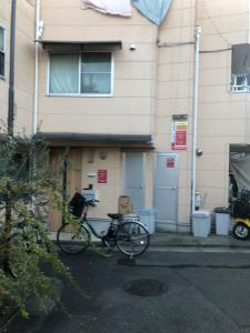 a bike parked in front of a building at Sunny moe oo in Tokyo