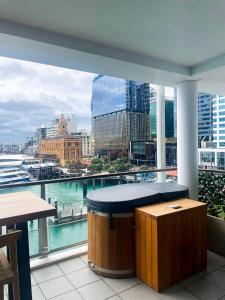 a balcony with a view of a city skyline at Luxury Apartment - Parking - Hot Tub - Stunning Views in Auckland