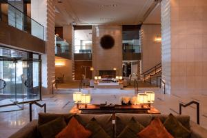 a lobby with a couch in the middle of a building at InterContinental Genève by IHG in Geneva