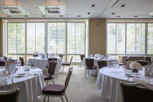 a banquet room with tables and chairs and windows at InterContinental Genève by IHG in Geneva