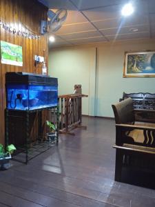 a room with a large aquarium and a table at Country View Inn in Sungai Lembing