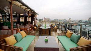 a restaurant with tables and chairs on a balcony at Kathmandu Height Boutique Hotel in Kathmandu