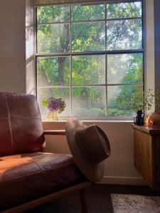 a living room with a couch and a large window at Westwood Lodge in Bright