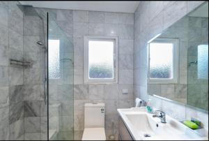 a bathroom with a toilet and a sink and a shower at 170Keppel Plantation House Bathurst in Bathurst