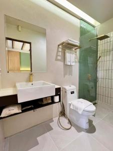 a bathroom with a sink and a toilet and a shower at Coral View Studio in Ko Tao