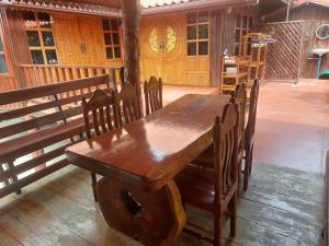 a wooden table and chairs in a room at Duangmanee Homestay in Ban Si Kaeo