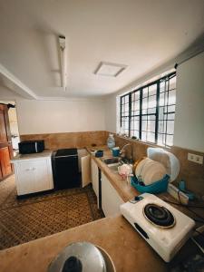 a small kitchen with a sink and a stove at Sky Rancho Hostel in Tagaytay