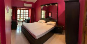 a bedroom with a large bed with a mirror at Calangute apartment in Calangute