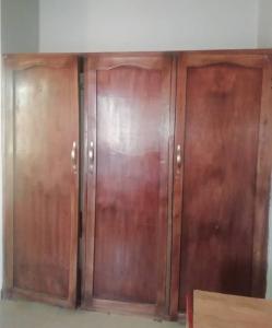 a pair of wooden doors in a room at Diamond Hotel close to Intl Airport, omole ikeja in Mawere