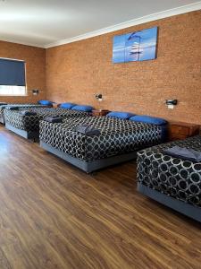 a conference room with black chairs and a brick wall at Coonamble Motel in Coonamble