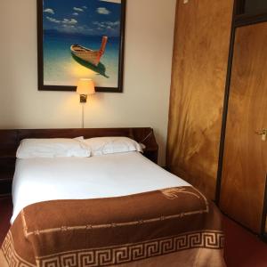 a bedroom with a bed and a picture of a boat at The Jericho Hotel in Oxford