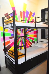 a bedroom with a bunk bed with a colorful wall at Prince Solo Hostel in Mumbai