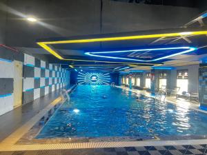 a large swimming pool with blue water in a building at Pearland -D'Eldorado Apartment in Hanoi