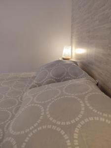 a bedroom with a bed with a pillow and a lamp at La Sérénade Numéro 1 in Montreuil