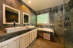 a bathroom with two sinks and a shower at Stay Wellbeing & Lifestyle Resort in Rawai Beach