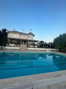 a large swimming pool in front of a house at VILLA in Tekirdag- Istanbul in Tekirdag