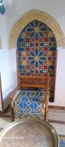 a chair in a room with a stained glass window at Golden Palace Garden in Luxor +27 photos