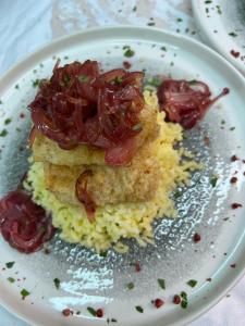 a white plate with food on top of rice at Agriturismo L'impero Romano in Gerace