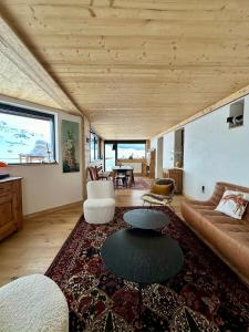 a living room with a couch and a table at Penthouse au cœur de Val Thorens in Val Thorens