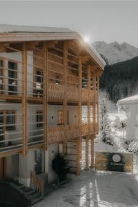 a large wooden building with snow on the ground at Haus Tyrol Gerlos in Gerlos