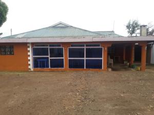 ein kleines Haus mit einer Orange in der Unterkunft RockVilla GuestHouse Njabini in South Kinangop