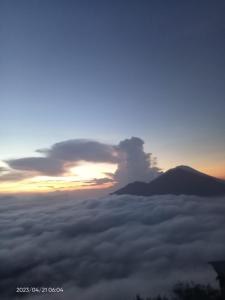 a view from above the clouds at sunset at jeep sunrise and trakking in Kintamani