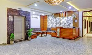 a lobby with a waiting room with benches and a door at Hotel Golden Glam in Agra