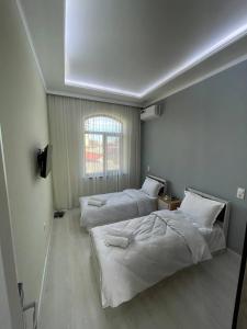a bedroom with two beds and a window at Tashkent hotel Parvoz in Tashkent