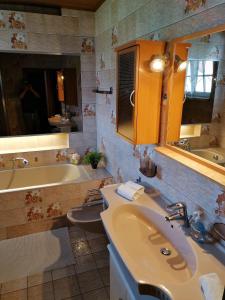 a bathroom with a sink and a tub and a sink at Sunshine Apartment in Köflach