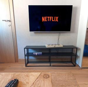 a black coffee table with a television on a wall at Apartman 519 - Aparthotel Vučko in Jahorina