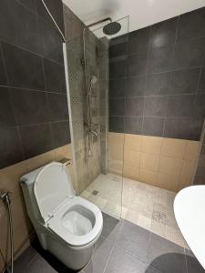 a bathroom with a toilet and a shower at West Port Hotel in Sihanoukville