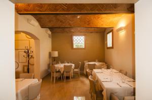 a dining room with tables and chairs and a window at Hotel Villa Maranello in Maranello