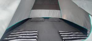 a close up of a bed in a tent at The Meraki Beach Resort in Gokarna