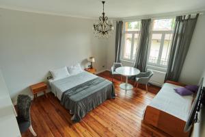 um quarto com uma cama, uma mesa e cadeiras em The Liberty Terrace em Udine
