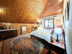 sypialnia z łóżkiem i drewnianym sufitem w obiekcie Forest cottage top of the world w mieście Vourgareli