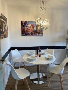 a dining room with a white table and chairs at Dicker Stein in Lambrecht